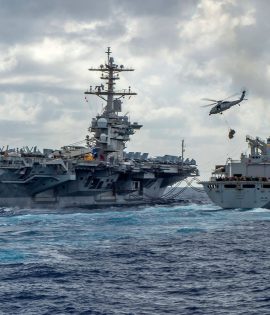 This handout picture released by the US Navy on May 8, 2019 shows the Nimitz-class aircraft carrier USS Abraham Lincoln (CVN 72) while conducting a replenishment-at-sea with the fast combat support ship USNS Arctic (T-AOE 9), while MH-60S Sea Hawk helicopters assigned to the "Nightdippers" of Helicopter Maritime Strike Squadron (HSM) 5, transfer stores between the ships. - The US is deploying an amphibious assault ship and a Patriot missile battery to bolster an aircraft carrier and B-52 bombers already sent to the Gulf, ratcheting up pressure on Iran. The USS Arlington, which transports marines, amphibious vehicles, conventional landing craft and rotary aircraft, and the Patriot air defence system will join the Abraham Lincoln carrier group, the Pentagon announced on May 10. (Photo by MCSN Jason Waite / Navy Office of Information / AFP)MCSN JASON WAITE/AFP/Getty Images